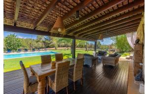a dining room with a table and chairs and a pool at Es Sequer in Felanitx