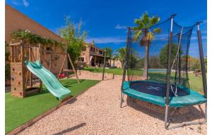 a playground with a slide and a swing set at Es Sequer in Felanitx