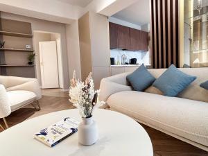 a living room with a couch and a table at YANG 23rd Floor Panoramic View & King Bed, Parkin in Cluj-Napoca