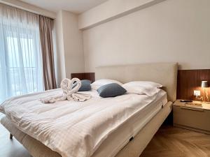 a bedroom with a bed with a bow on it at YANG 23rd Floor Panoramic View & King Bed, Parkin in Cluj-Napoca