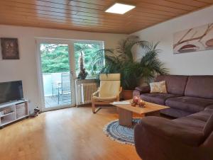 a living room with a couch and a table at Hillis Ferienwohnung Saarland in Sankt Ingbert