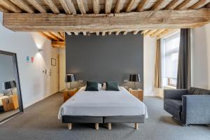 a large bedroom with a bed and a couch at Hotel De Groene Hendrickx in Hasselt +69 photos