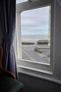 a window with a view of an empty parking lot at Sunset Suites in Blackpool