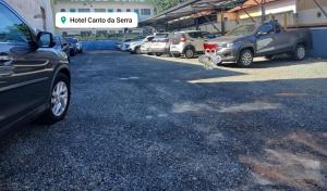 a parking lot with cars parked in front of a building at Hotel CANTO DA SERRA in Caldas Novas +29 photos