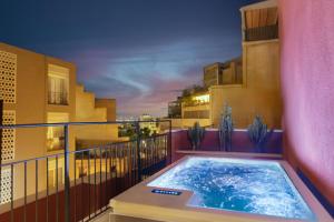 a hot tub on the balcony of a building at Anise Aluma Athens, Tapestry Collection by Hilton in Athens