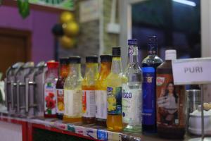 a row of bottles of alcohol on a shelf at ANAND LOK VARANASI in Varanasi