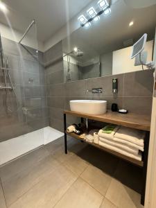 a bathroom with a sink and a shower at Malvezzi24 Boutique Rooms in Desenzano del Garda
