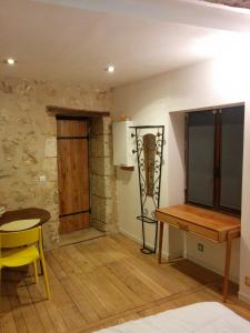 a room with a table and a wooden floor at Tour Duguesclin in Chauvigny