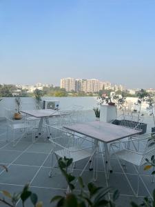a group of tables and chairs on a roof at The Niruma Villa in Udaipur