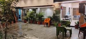 an office with a lot of plants and chairs at ANAND LOK VARANASI in Varanasi +15 photos