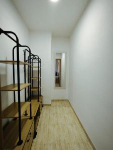 a room with wooden shelves and a white wall at Las Salinas in Roquetas de Mar