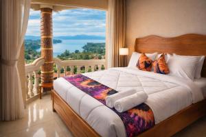 a bedroom with a bed with a view of the water at Kivu Go-Lax Resort in Gisenyi +57 photos