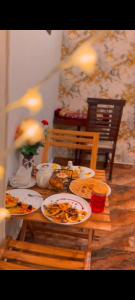 a table with plates of food on top of it at Hotel DE Smart Multan in Multan