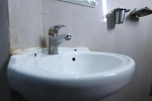 a sink with a faucet in a bathroom at ANAND LOK VARANASI in Varanasi