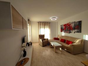 a living room with a couch and a table at Las Salinas in Roquetas de Mar