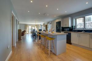 a kitchen with a island with bar stools at 3 Bed in Coelbren oc-way238 in Coelbren