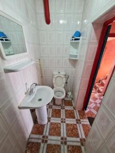 a small bathroom with a toilet and a sink at Maison Banana in Aourir