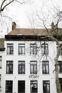 a white building with a rory sign in front of it at ROMY ANTWERP Sint-Jansvliet in Antwerp