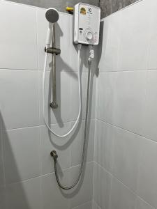 a shower with a hose attached to a wall at Green Mountain Resort Koh Yao in Ko Yao Yai +88 photos