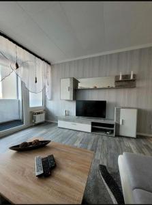 a living room with a table with two remote controls on it at Sarra&Mo Ferienwohnung in Duisburg