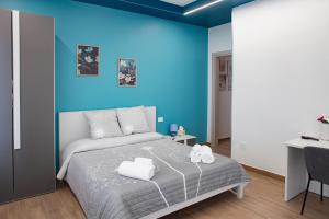 a bedroom with a bed with a blue wall at Acquamarina B&B in Vasto