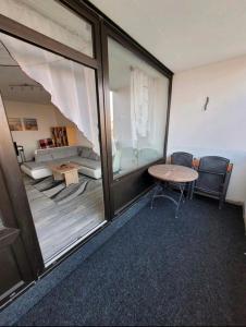 a room with a large window and a table and chairs at Sarra&Mo Ferienwohnung in Duisburg