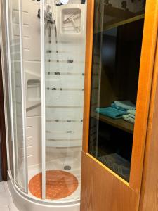 a shower with a glass door in a bathroom at Metis Apartments Bellizzi in Bellizzi +39 photos