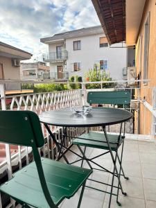 a patio table and chairs on a balcony at Metis Apartments Bellizzi in Bellizzi