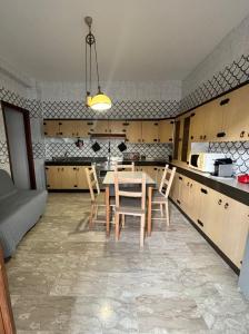 a kitchen with a table and chairs in a room at Metis Apartments Bellizzi in Bellizzi
