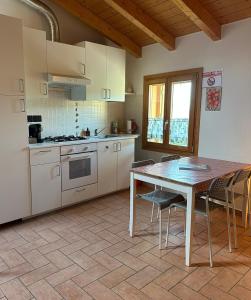a kitchen with a table and chairs and a table and a table and a kitchen at Castello San Romano in Baiso