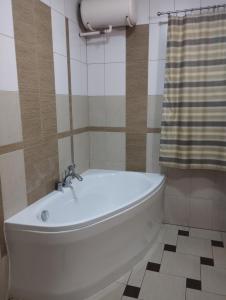 a white bath tub in a bathroom with a shower at DW Łomnica in Białka Tatrzańska +32 photos