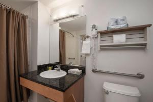a bathroom with a sink and a toilet and a mirror at Fraser Crossing 3518 Studio in Winter Park +14 photos
