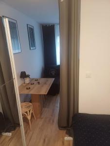 a room with a wooden table and a mirror at Crystal Baltic Studio Gdańsk self check in - 24h in Gdańsk