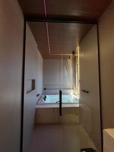 a bath tub in a room with a window at Âmbar Chalés 2 in Ametista do Sul +2 photos