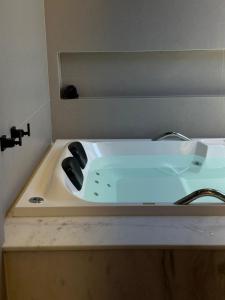 a white sink in a bathroom with a mirror at Âmbar Chalés 2 in Ametista do Sul