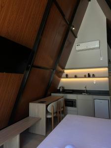 a small kitchen with a table and a sink at Âmbar Chalés 2 in Ametista do Sul