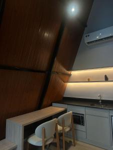 a kitchen with a table and chairs and a sink at Âmbar Chalés 2 in Ametista do Sul