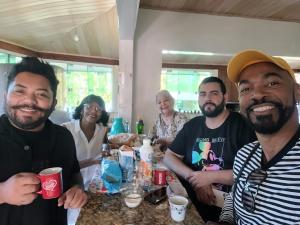 a group of people posing for a picture at a table at Descanso merecido in Morretes