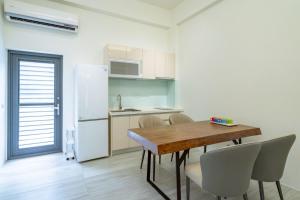 a kitchen with a table and chairs and a refrigerator at Yunheyue B&B in Suao
