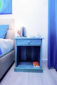a blue nightstand with a phone on it next to a bed at Blue Maalu Resort in Ambalangoda