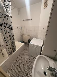 a bathroom with a toilet and a tub and a sink at Turp Residenz Fewo in Blomberg