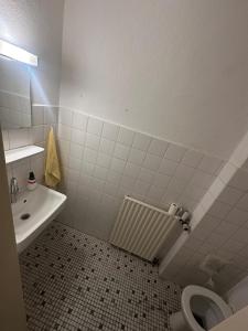 a bathroom with a toilet and a sink at Turp Residenz Fewo in Blomberg