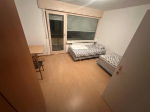 an empty room with two beds and a window at Turp Residenz Fewo in Blomberg