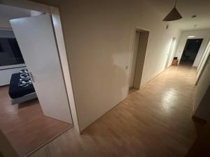 an empty room with a white door and a wooden floor at Turp Residenz Fewo in Blomberg