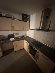 a small kitchen with a sink and a stove at Turp Residenz Fewo in Blomberg