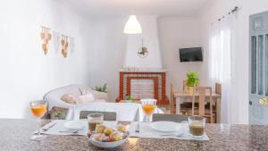 a living room with a table with a bowl of fruit at Villa Quevedo Torrox by Ruralidays in Torrox