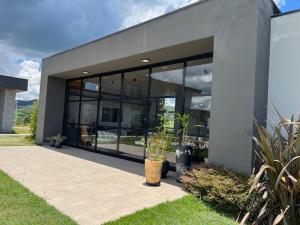 a building with large glass windows and a potted plant at Le Chateau Lavande in Balsa Nova