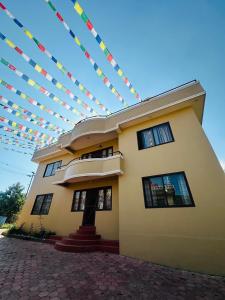 a house with a string of flags above it at Pharping StayInn in Pharping