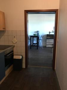 a door to a kitchen with a table in the background at Gutshaus Breesen in Laage