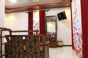 a living room with a mirror and red curtains at Wadula Resort in Nochchiyagama